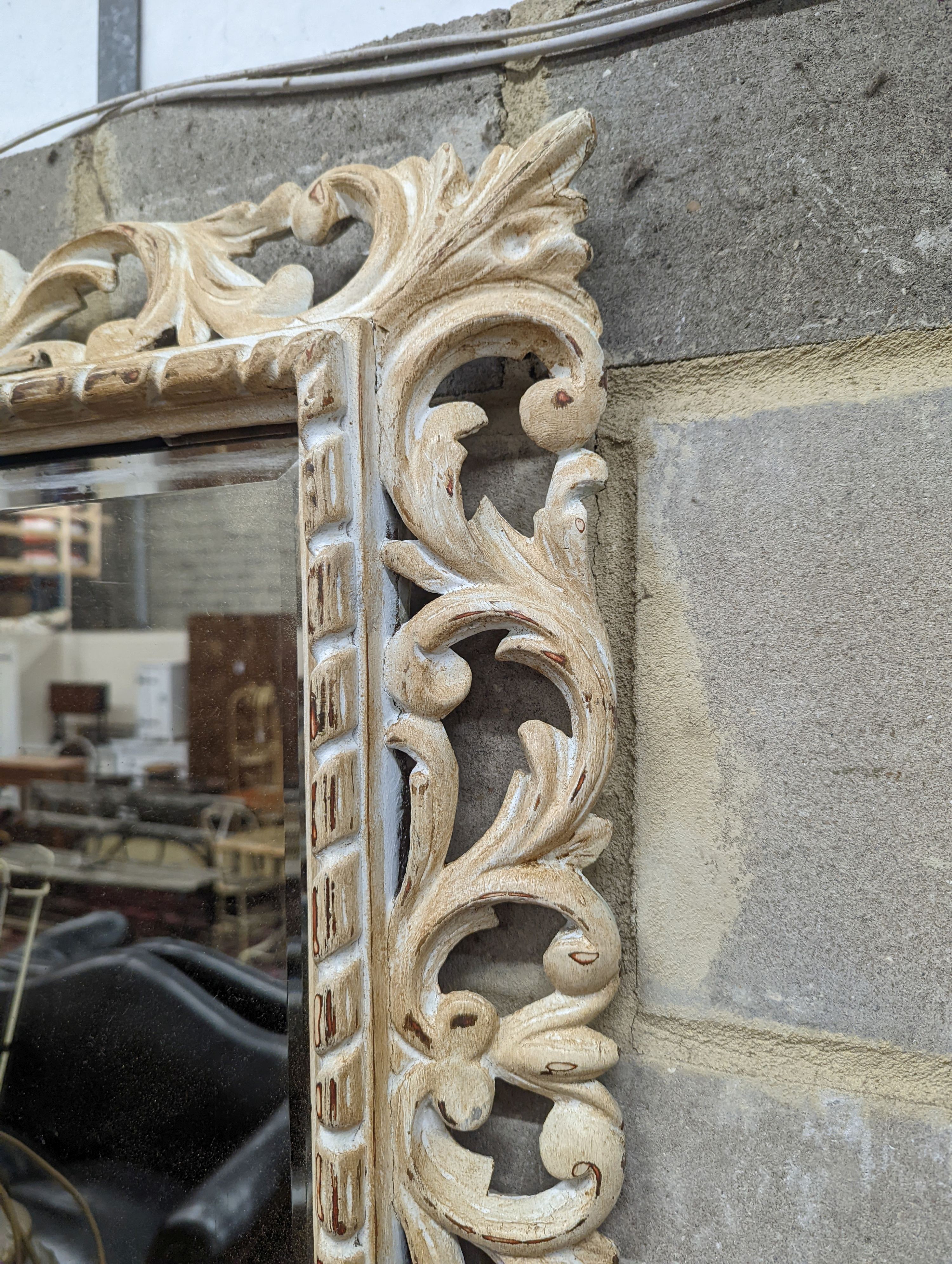 A painted rectangular pierced pine wall mirror, width 78cm, height 64cm